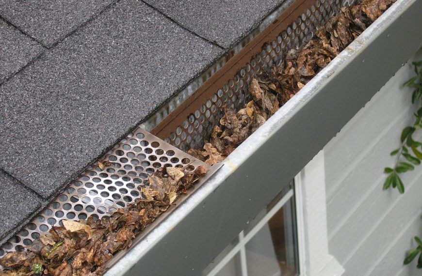 gutter guard with an accumulation of dried, brown leaves