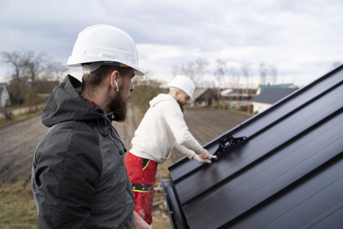 two men working on gutters